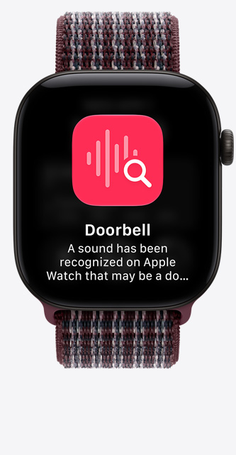 Apple Watch Series 12, pouzdro z černého hliníku, obrazovka s připnutými konverzacemi, burgundsky kostkovaný provlékací sportovní řemínek