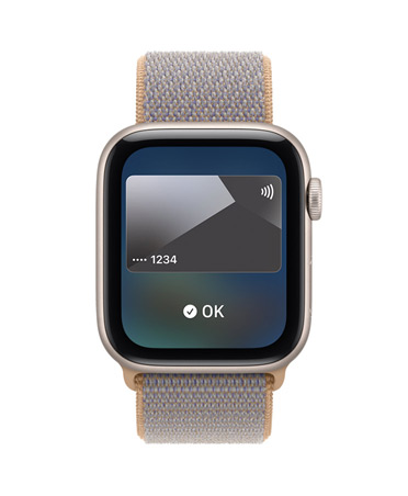 Apple Watch SE 3, aluminum case, starlight color, screen shows Wallet, payment card graphic, right side exterior, Digital Crown dial, Sport Loop band, chambray blue color (light blue-gray)