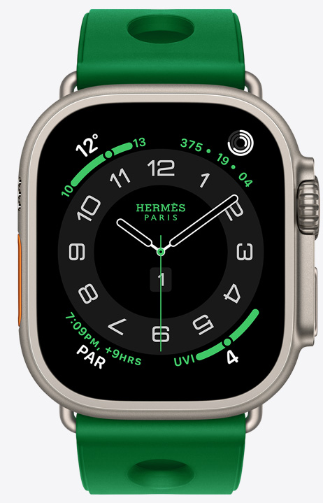 Apple Watch Hermès Ultra 4, Circulaire analog watch face, (hour, minute and second hands, complications: Weather, Activity rings, Paris time and UV index), titanium case, natural color, right side exterior, Digital Crown, raised side button, paired with Scub'H Diving band, Vert Vertigo color (bright green), molded rubber material, circular cutouts centered