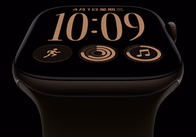 Apple Watch Series 12，展示深古銅色鋁金屬錶殼，搭配橄欖色運動型錶帶，螢幕顯示組合錶面與多項複雜功能，包括日期、體能訓練、活動記錄圓圈與 Apple Music，右側外觀展示數位錶冠