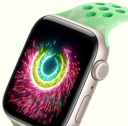 Apple Watch SE 3, screen shows Activity rings sparking like fireworks, aluminum case, starlight color, connected to Nike Sport Band, green spark color (mint green, subtle pattern of gray shapes, circular perforations)