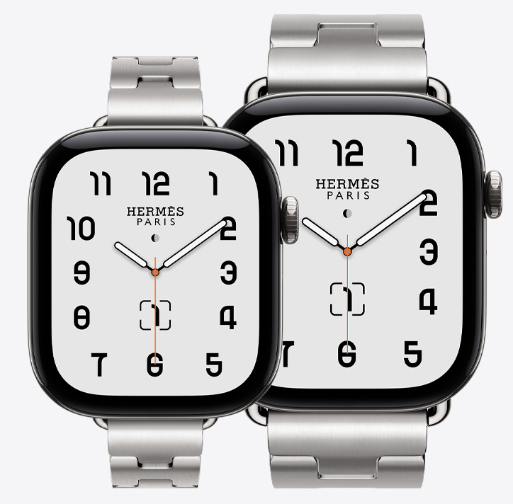Apple Watch Hermès Series 12，展示 42 毫米和 46 毫米型號，經典指針錶面 (時針、分針和秒針，複雜功能：月相、日期)，銀色鈦金屬錶殼，42 毫米型號配搭 Satiné 緞灰色 Grand H Fin 錶帶，46 毫米型號配搭 Satiné 緞灰色 Grand H 錶帶