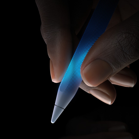 Une personne tient un Apple Pencil Pro. La zone située devant la pointe de l’Apple Pencil est sensible au toucher, mettant en valeur le retour haptique