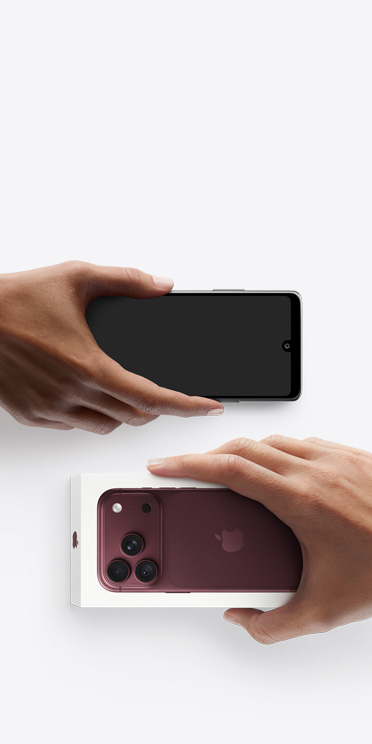 Hands exchanging phones, Android on the left without box, new iPhone 18 Pro, burgundy colour (dark red), in box, on the right